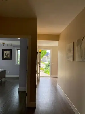 an empty living room with a door leading to a yard at Relaxing Lakeview 2 bedroom entire suite in Kelowna
