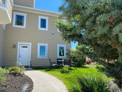 a house with a table and chairs in the yard at Relaxing Lakeview 2 bedroom entire suite in Kelowna