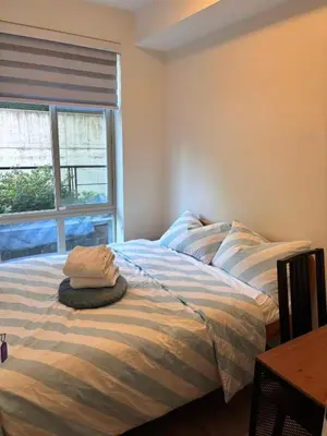 a bed with two pillows on it in a room with a window at Private Room in Vibrant Vancouver - with share living room and kitchen in Vancouver