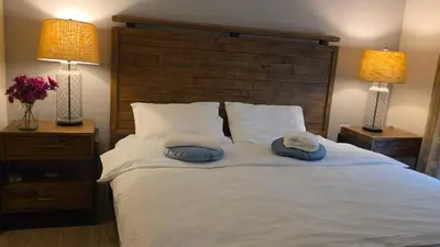 a bedroom with a large bed with two pillows on it at Private Room in Vibrant Vancouver - with share living room and kitchen in Vancouver