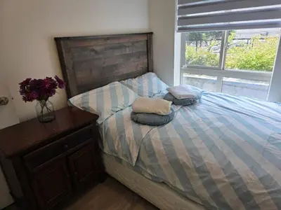 a bedroom with a bed with two pillows on it at Private Room in Vibrant Vancouver - with share living room and kitchen in Vancouver