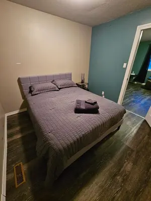 a bedroom with a large bed in a room at Cozy Bungalow