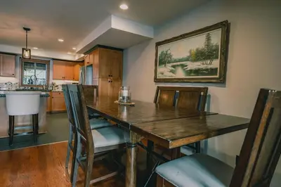 a dining room with a wooden table and chairs at Snow Reason A in Big White