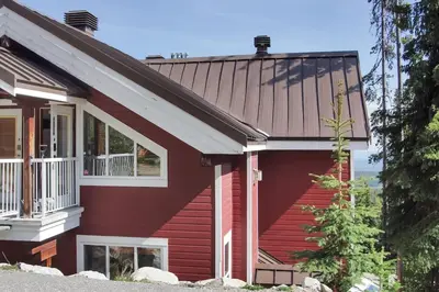 a red house with a gambrel roof at Snow Reason A in Big White