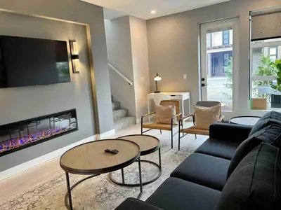 a living room with a couch and a tv at Parksville Townhome 2 bedroom pool gym in Parksville