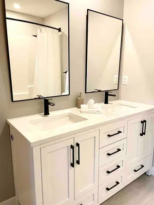 a bathroom with a white sink and two mirrors at Parksville Townhome 2 bedroom pool gym in Parksville