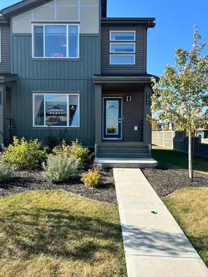 a green house with a sidewalk in front of it at 1-BR Suite with Private entrance near Restaurants, Shops, Local Amenities in Edmonton