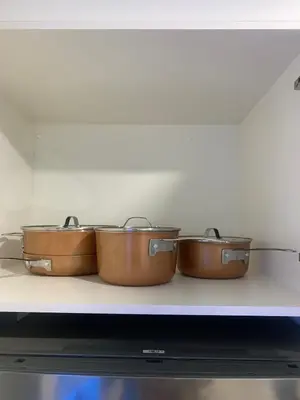 a row of pots sitting on a shelf in an oven at Modern 1BR Entire Suite Near Airport in Calgary