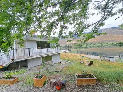 a house with three flower boxes in the yard at Private Bedroom at Riverfront House in Kamloops