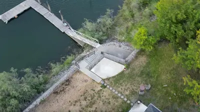 an aerial view of a house next to a body of water at Private Bedroom at Riverfront House in Kamloops