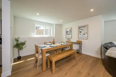a dining room with a table and chairs at Forest Haven on the Ridge in Prince George