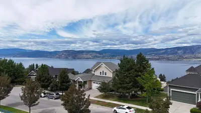 a house with a view of a lake and mountains at SHARED Lakeview Peaceful 2BR Stay in Beautiful Kelowna in Kelowna