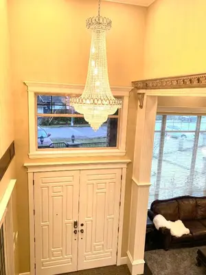a chandelier hanging over a cabinet in a room at Sakura Stay two bedrooms with a private bathroom in Richmond