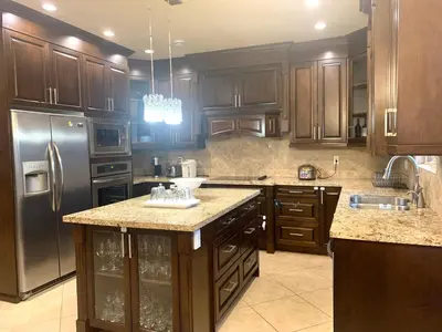 a kitchen with wooden cabinets and stainless steel appliances at Sakura Stay two bedrooms with a private bathroom in Richmond