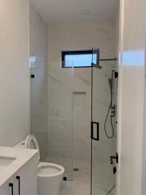 a bathroom with a glass shower with a toilet at Calm & Cozy Private Suite in Surrey