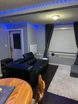 a living room with a couch and a table at ComfyComfort in Calgary