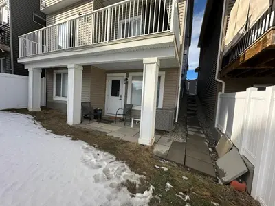a porch of a house with snow on the ground at ComfyComfort in Calgary