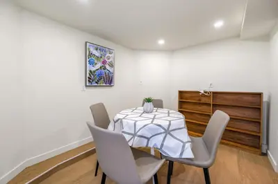 a dining room with a table and chairs at Picturesque room surrounded by flowers with share spaces in Vancouver