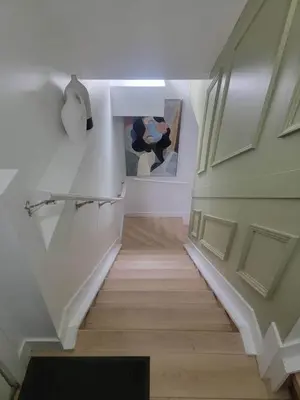 a staircase in a house with a painting on the wall at Shiloh Residence in Edmonton