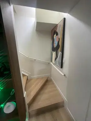 a staircase with a painting of a dog on the wall at Shiloh Residence in Edmonton