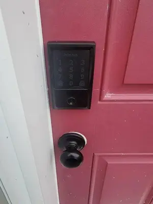 a red door with a remote control on it at Shiloh Residence in Edmonton