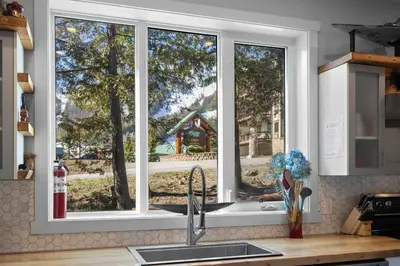 a window in a kitchen with a sink and a counter top at 4-bedroom with Game Room & Hot Tub in Fernie