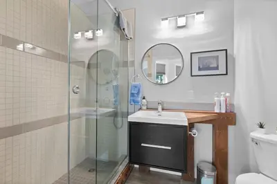 a bathroom with a glass shower and a sink at 4-bedroom with Game Room & Hot Tub in Fernie