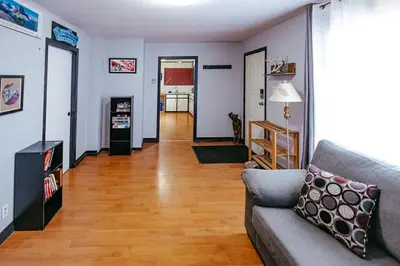 a living room with a couch and a hard wood floor at Pet-Friendly Invermere Home with Firepit by StayIn in Lake Windermere