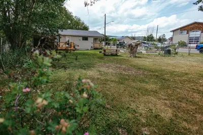 a yard with a picnic bench and a house at Pet-Friendly Invermere Home with Firepit by StayIn in Lake Windermere