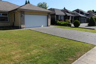 a house with a garage and a driveway at Guest Suite in Maple Ridge in Maple Ridge District Municipality