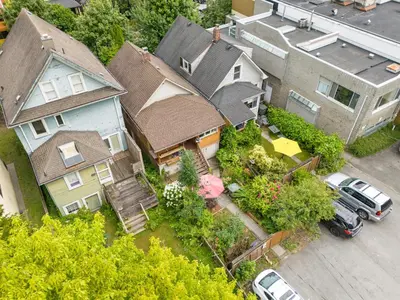an aerial view of a house with cars parked in front at Adorable Kits Home with Balcony and Garden Retreat in Vancouver