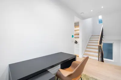 a dining room with a black table and two chairs at Duplex in West Point Grey with Parking and Balcony in Vancouver