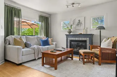 a living room with a couch and a fireplace at Kinepik Cottage Sunroom with Beach Access in Sylvan Lake