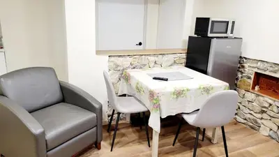 a kitchen with a table with a chair and a laptop at 4-Bedroom Home by Downtown and Airport in Calgary