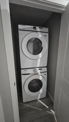 a washer and dryer in a small room at Spruce Meadows Place in Calgary