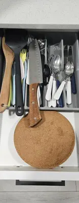 a knife and other kitchen utensils in a drawer at Spruce Meadows Place in Calgary