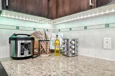 a kitchen counter with a coffee maker and a microwave at 17th Avenue Paranomas Escape in Calgary