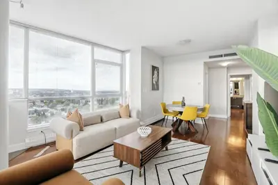 a living room with a couch and a table at 17th Avenue Paranomas Escape in Calgary