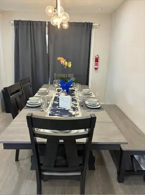a dining room table with chairs and a dining room table at Cozy 3-Bedroom Retreat in Surrey Share Save in Surrey