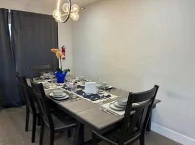 a dining room table with chairs and a dining room at Cozy 3-Bedroom Retreat in Surrey Share Save in Surrey