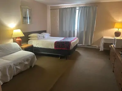 a hotel room with two beds and a window at Villagers Inn in Fruitvale