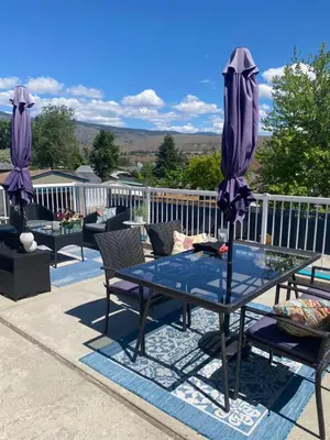 a table with an umbrella on a patio at Mountain View Villa with Saltwater Pool in Oliver
