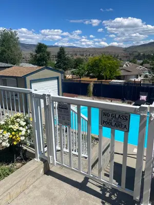a sign on a fence with a no glass pool table at Mountain View Villa with Saltwater Pool in Oliver