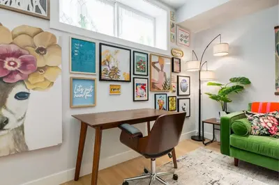 a home office with a desk and a green chair at Santuario Kensington - Inner City Escape in Calgary