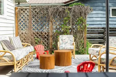 a group of chairs and tables on a patio at Sylvan Cabin - 3 BR Family Fun Luxurious Yard in Sylvan Lake