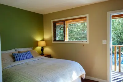 a bedroom with a bed and a window at Skeena River House Bed & Breakfast in Terrace