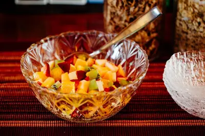 a bowl of fruit with a spoon in it on a table at Skeena River House Bed & Breakfast in Terrace