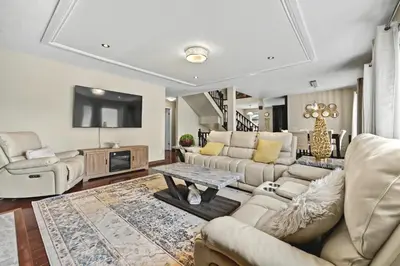 a living room with a couch and a tv at Calgary - By Mountains and Ski in Calgary