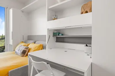 a white desk in a room with a bed at Central Kelowna TOP FLOOR rooftop patio in Kelowna