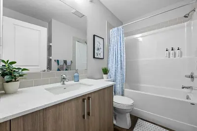 a bathroom with a sink and a toilet and a tub at Relax in Comfort, AC, YYC, CrossIron Mills, Banff in Calgary